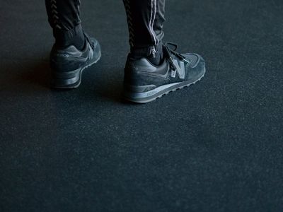 Detail of sports shoes on dark textured floor