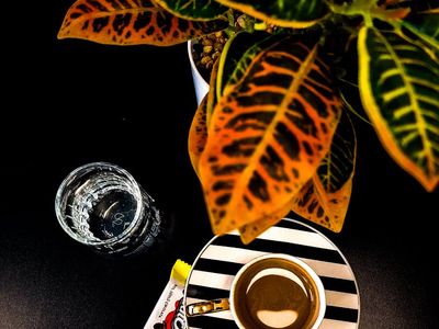 Glass of water on a black table with reflection